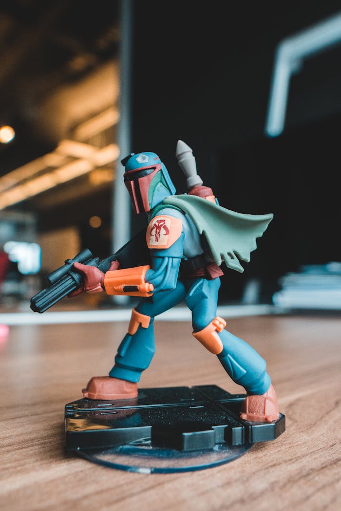 services-03 Close-up of a vibrant superhero action figure posed dynamically on a wooden table indoors.